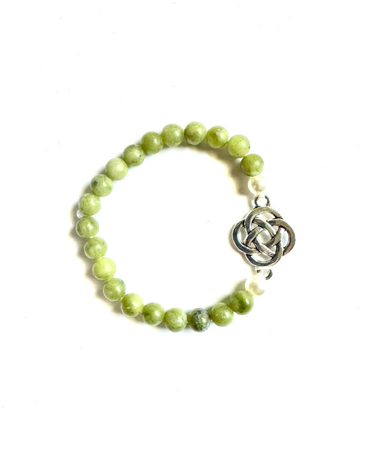 Celtic jade bracelet featuring green stone beads and a silver knot charm for a stylish accessory